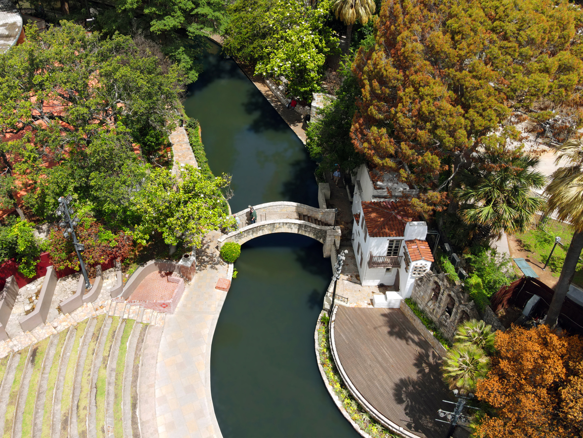 Aerial view of bridge, amphitheater, and waterway of San Antonio Riverwalk