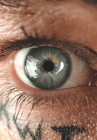 gray-eye-of-man-with-letters-on-face-skin