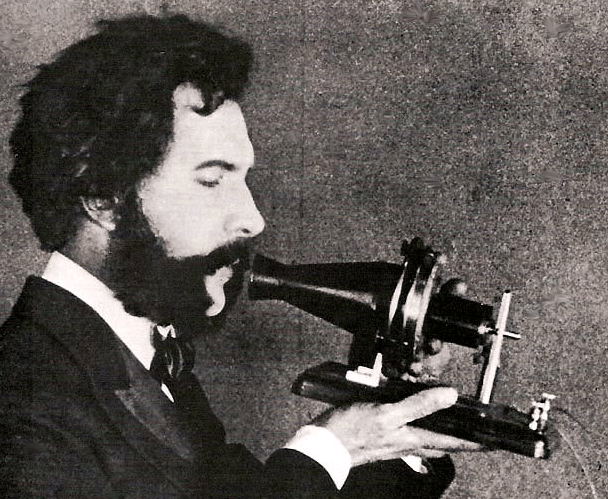 An actor playing Bell in a 1926 film holds Bell's first telephone transmitter