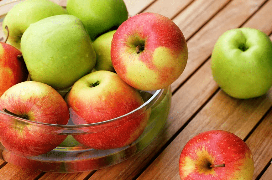 green and red apples in a bowl