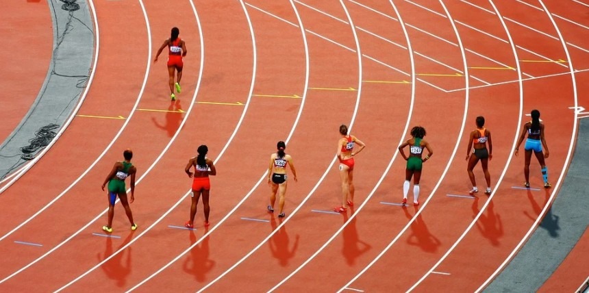 Eight women getting ready to run in a race track