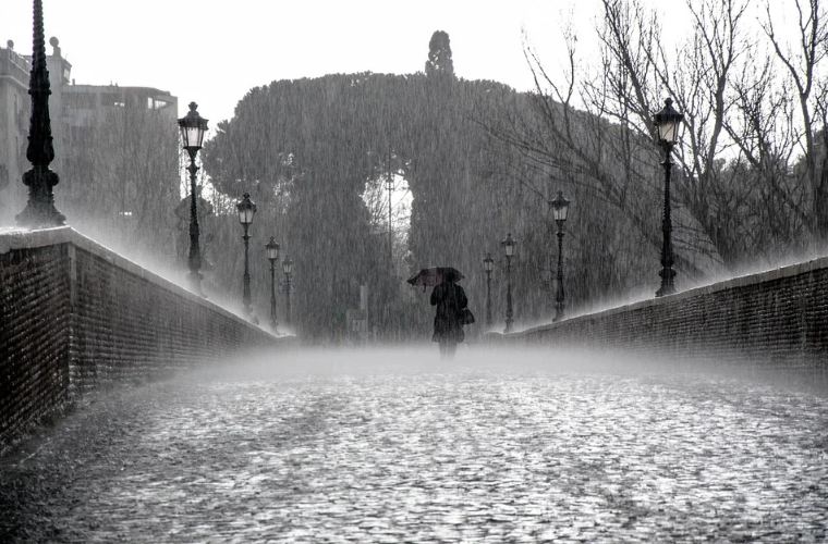 A woman walking in bridge under heavy rains