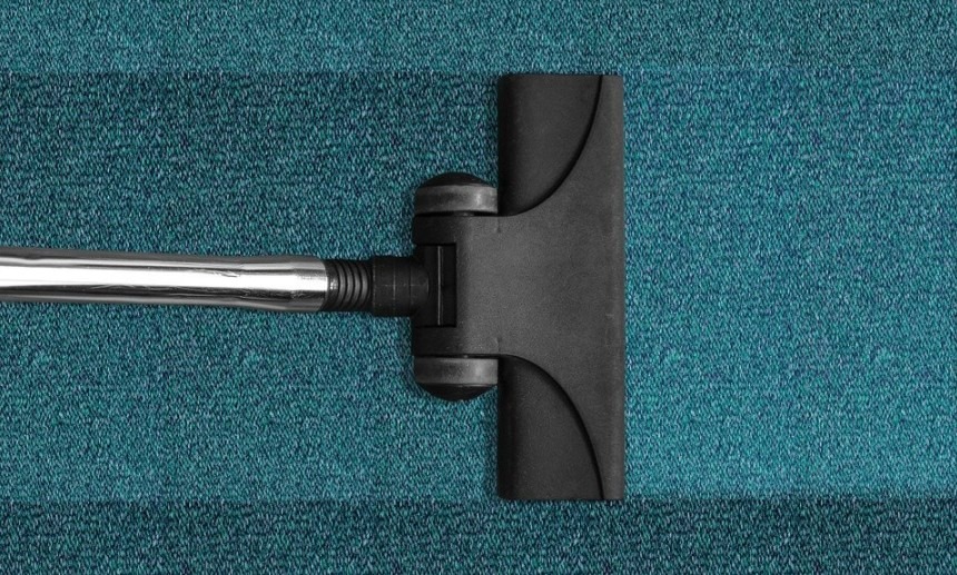 Vacuum on a blue green carpet