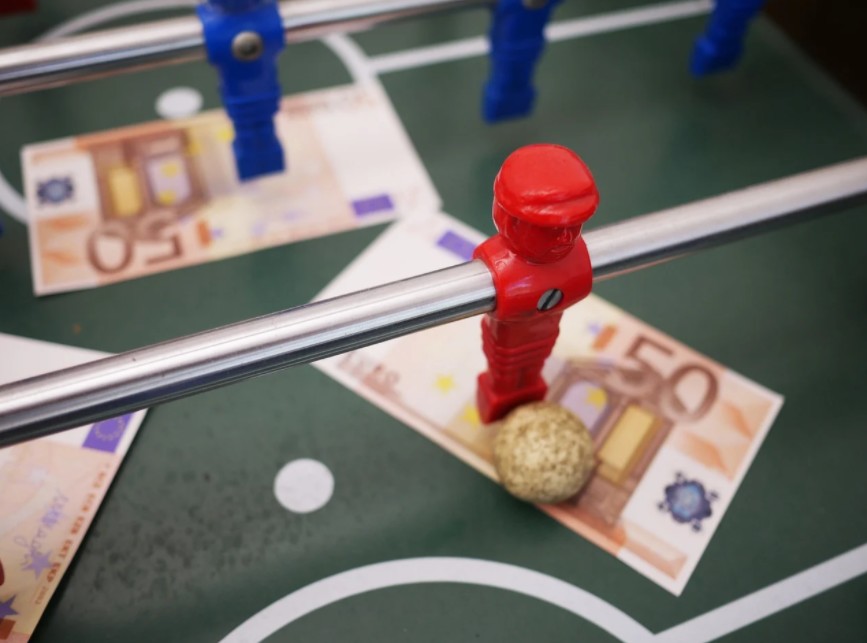Foosal red player on a 50 euro bill note sports betting