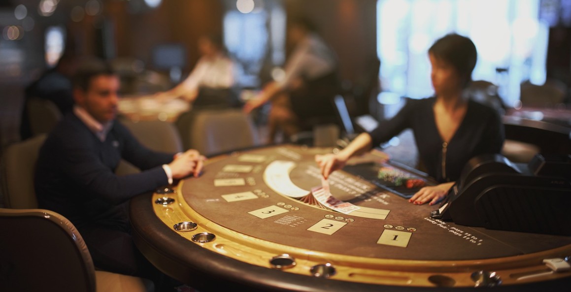 Two men in a suite playing blackjack gambling on a semi-circle table