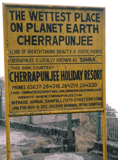 A signboard saying “the wettest place on planet earth Cherrapunjee”