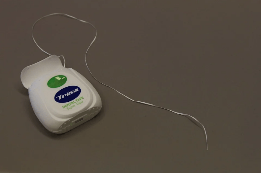 an open dental tape, a thread of dental tape
