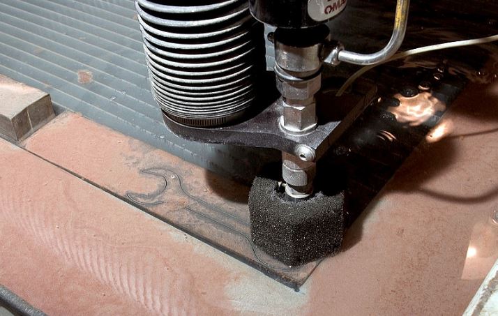 a water jet cutting a metal tool