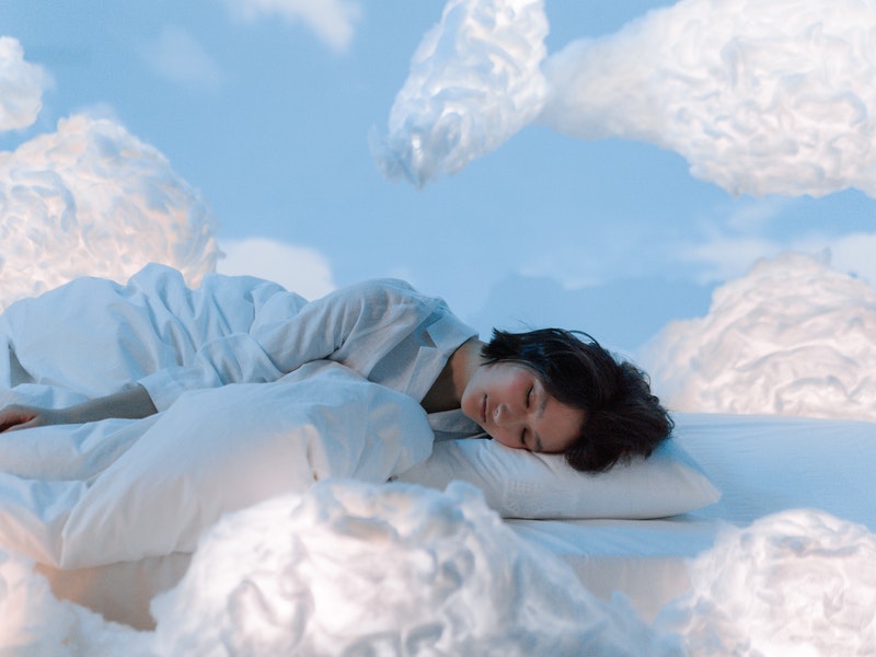 a woman sleeping surrounded by clouds
