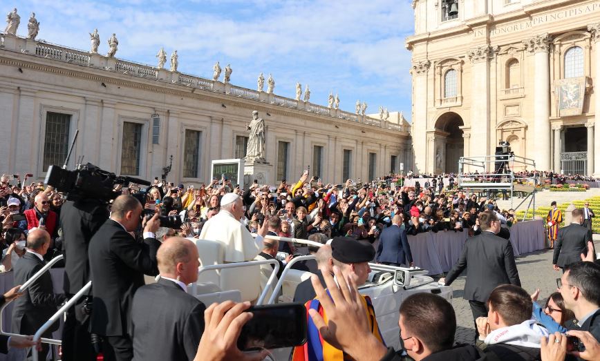 Pope surrounded by people and guards